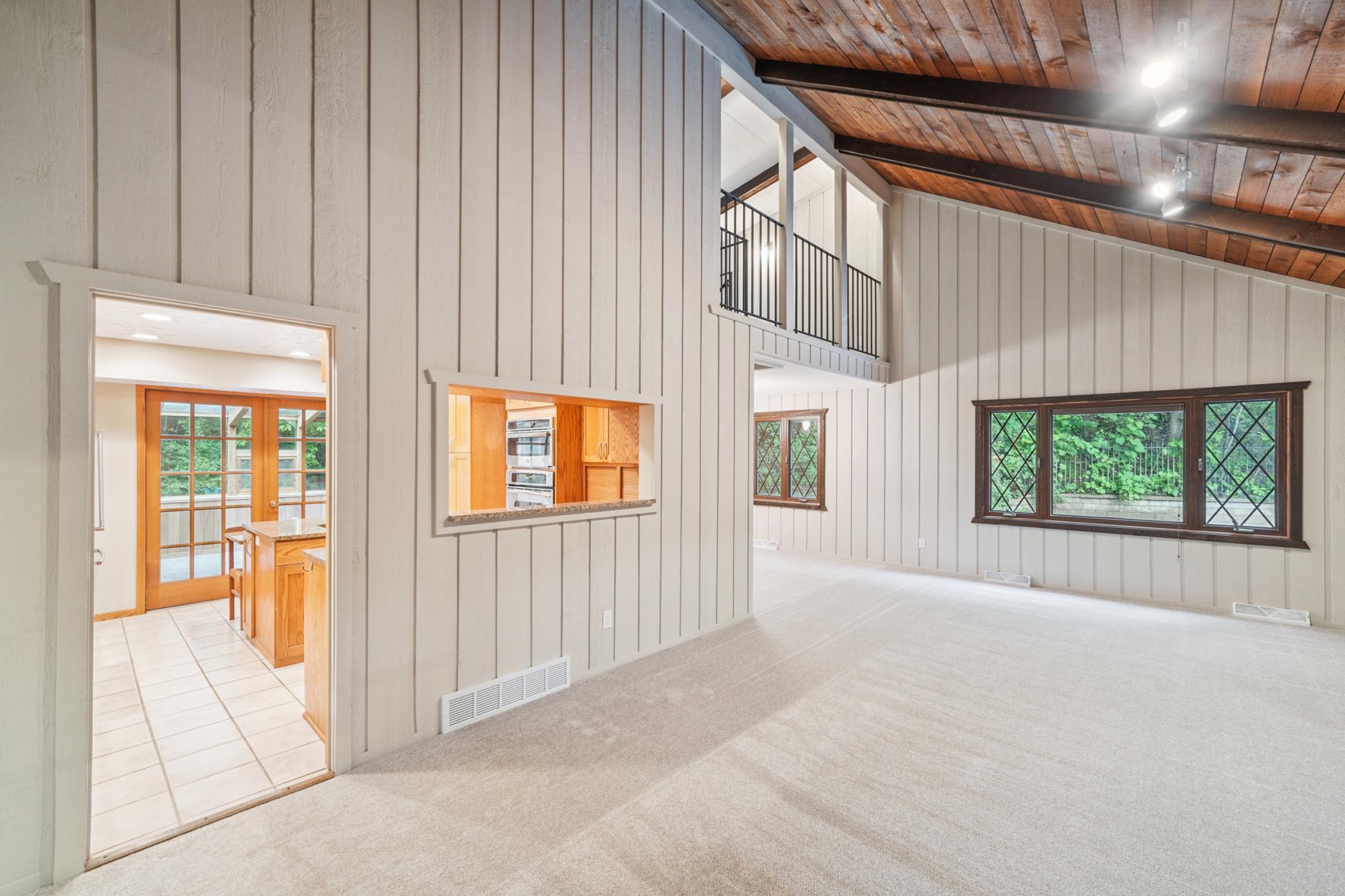 Upper level living room with soaring ceilings.