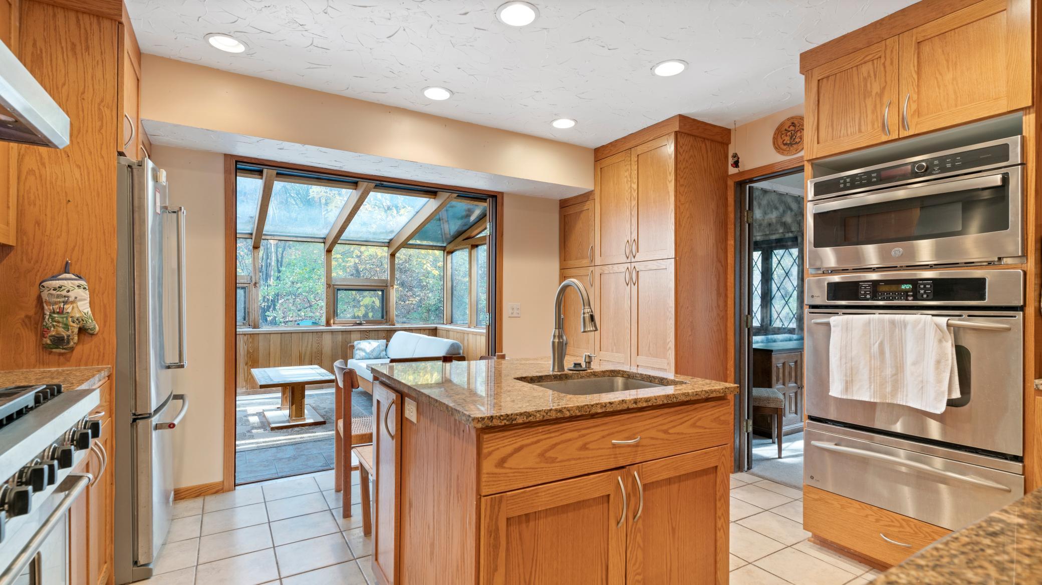 Large kitchen with center island with sink.