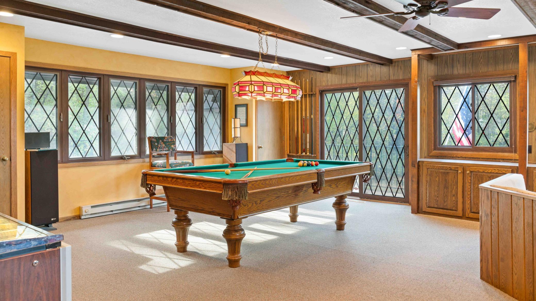 Large bonus space above garage with deck leading to pool area