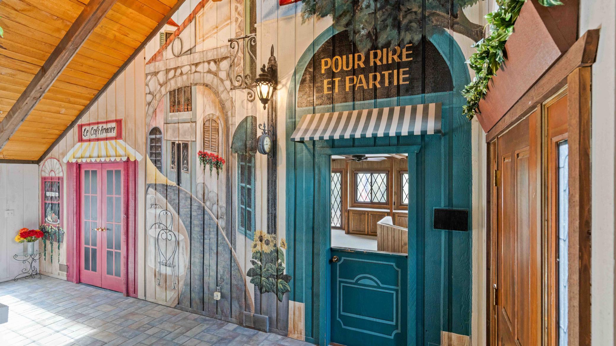 Large foyer with custom "Paris" themed design and split door to game room