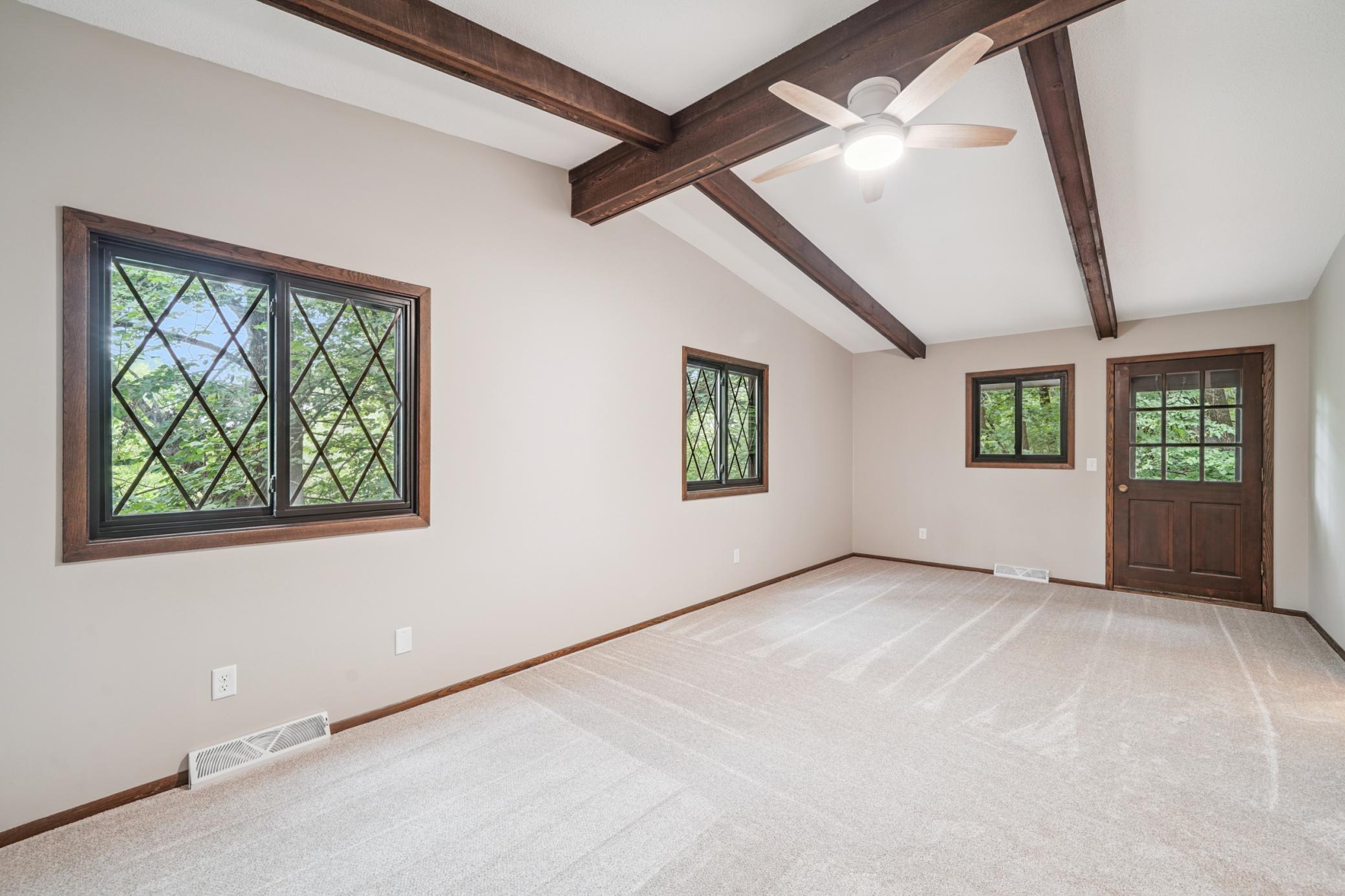 Large primary bedroom with vaulted ceilings and walk in closet