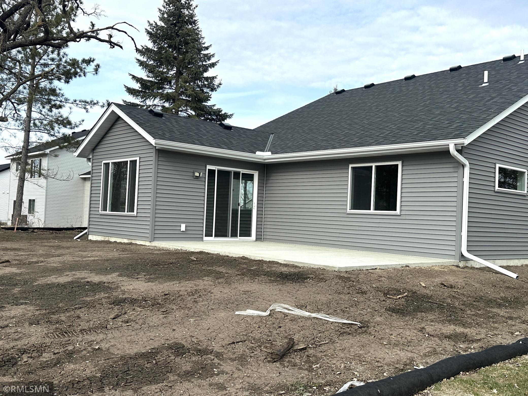 Open spacious patio off the sun room ideal for outdoor entertaining and relaxing. Great view overlooking the community park and green space.