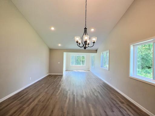 The open design features a wide open space from the kitchen to the sunroom. The wall is lined with windows so natural sunlight and views of the outdoors enhances this area of the home.