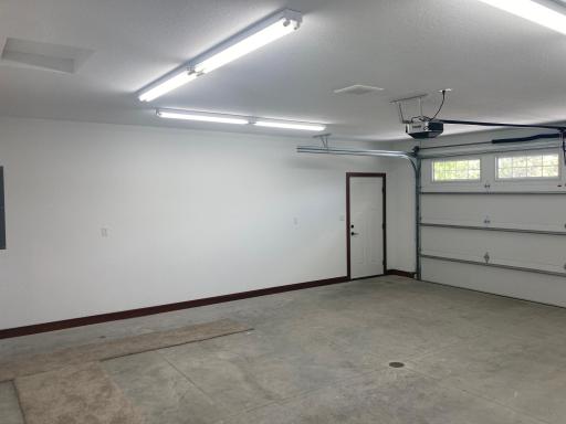 Garage is finished-tape, mud, paint, & trim. Extra lighting along with a floor drain!