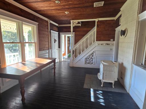 Dining area with wood pellet stove. Staircase in the background.