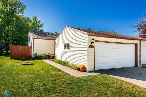 Exterior Photo showing double garage, twin home & privacy fence for Patio