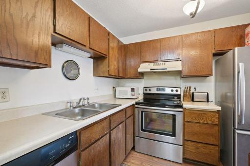 Kitchen features stainless appliances and wood cabinetry. Microwave included with the home.