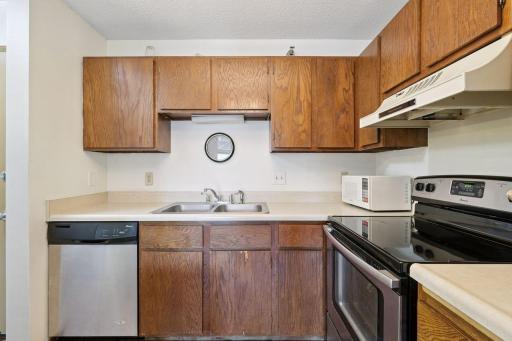 Kitchen features stainless appliances and wood cabinetry. Microwave included with the home.