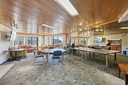 Having a big event? This enclosed party room has open sliding doors to the rooftop patio. Fully equipped kitchen, large screen TV, seating, even a piano (not shown in this picture).