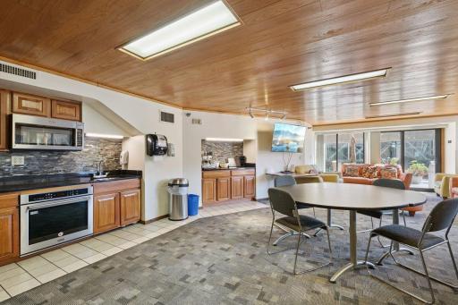 Having a big event? This enclosed party room has open sliding doors to the rooftop patio. Fully equipped kitchen, large screen TV, seating, even a piano (not shown in this picture).