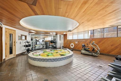 Get refreshed and relax in this jumbo hot tub spa in the 3rd floor spa and gym. The floaties are there to keep the heat in when not in use. Take a look to the left at the wooden door on the wall that leads to ...