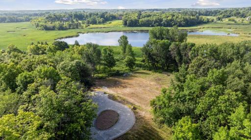 Located on the peninsula of a pond, this site offers expansive natural views.