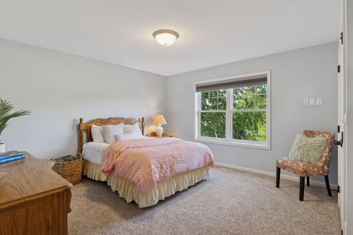 Generously sized bedrooms on the upper level each have access to a bathroom. This room shares the well-appointed jack-n-jill bathroom.