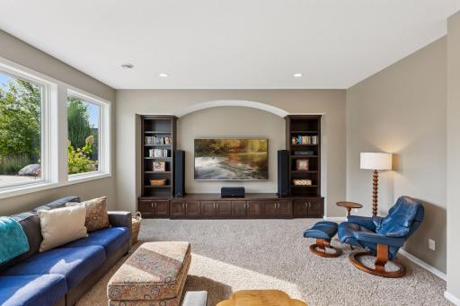 The spacious TV area looks out to the fire pit and the pool deck.