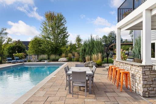 Welcome to the pool deck and patio with multiple spaces for both lounging and entertaining.