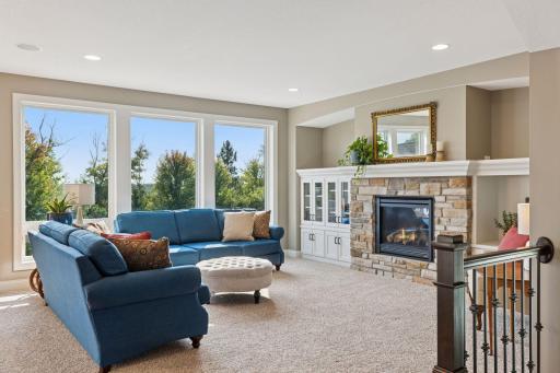 The oversized windows in the living room overlook the pool and backyard.