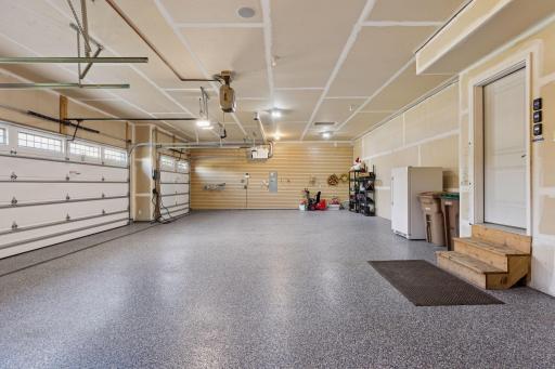 The sparkling epoxy floors aren't the only high end feature in this well-maintained 4-car garage. Check out the ceiling mounted hose reel and expansive floor drain for washing your cars and favorite toys!