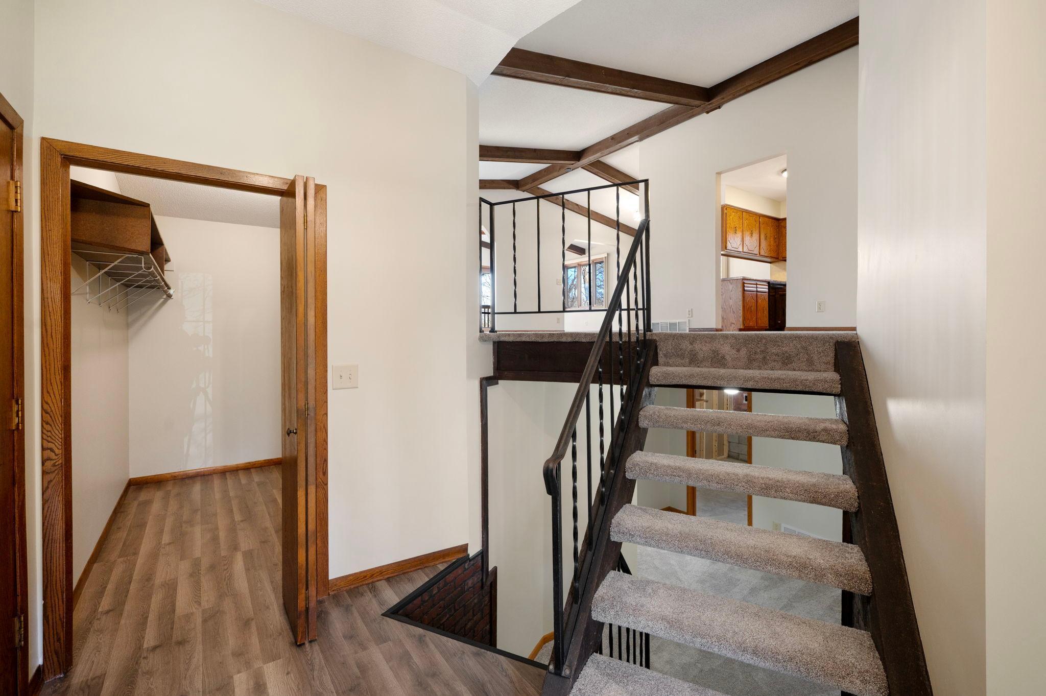 walk in closet and stairs going to upper level, and lower level