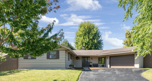 Primary front photo, large driveway, oversized garage with full size pass through door to back yard.