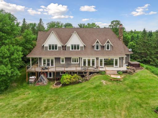 Floor to ceiling windows, wrap around porch and hot tub ready for those crisp MN nights.