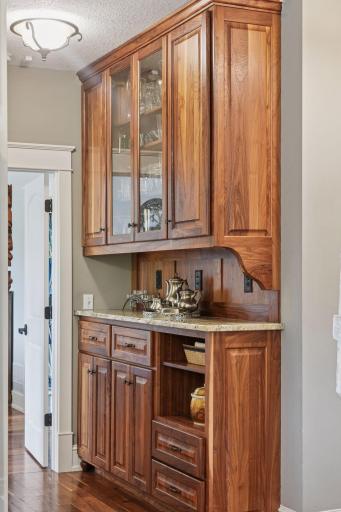 Gorgeous walnut butler's pantry with granite countertops