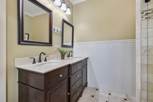 Dual vanity, marble flooring and stone countertops.