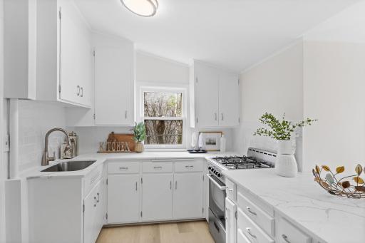 Main level - Remodeled kitchen with quartz counters and brand new lvp
