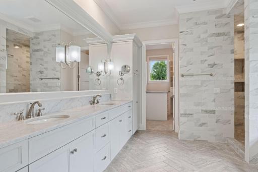 The primary suite bath offers a spacious dual bowl vanity that provides ample room for both partners to prepare for the day ahead.