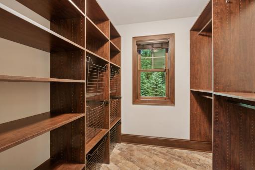 A true drop-zone essentialâthis mudroom closet has space for coats and cubbies for shoes and closet keeps the entry as tidy and daily essentials organized.
