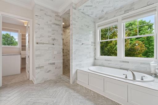 The soaking tub offers the perfect setting for relaxation, whether youâre immersed in a good book or savoring a glass of wine. An expansive walk-in shower adds to the experience, offering room to reset and recharge....