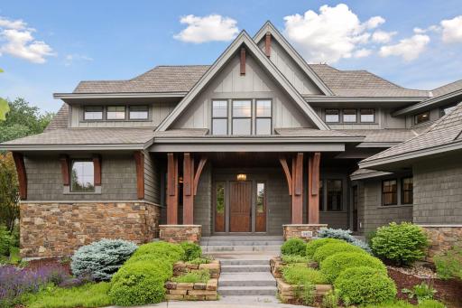 This gracious entry is framed by architectural details and mature landscaping.