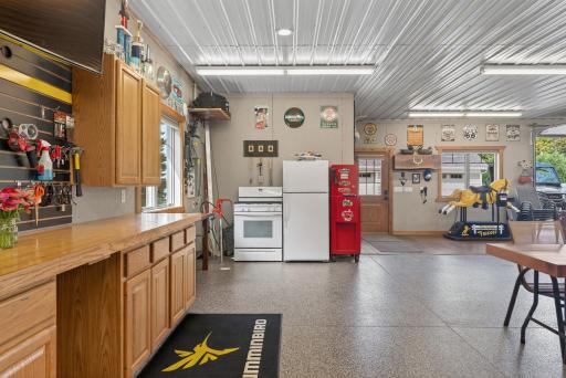Complete with in-floor heat, portable air conditioner, built-in cabinetry, a stove, refrigerator, and a three-quarter bath.