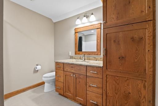 They are serviced by a full bathroom featuring a combination tub and rain shower and built-in linen storage.