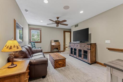 The upper level opens to a spacious loft with plush carpeting, ideal as a home office, reading nook, or sitting area.