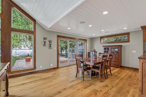 Seamlessly flowing from the living room, the dining area continues the rich wood flooring and opens directly to the patio, making indoor-outdoor entertaining effortless and enjoyable.