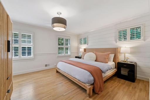 Lovely primary suite with wood floors, two closets and private backyard views