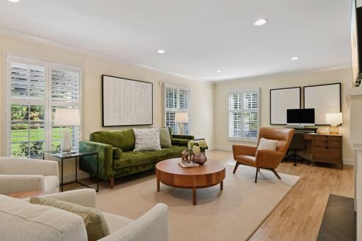 Walls of windows stream light throughou tthe day and plantation shutters are wonderful and thoughtfully placed throughout the home