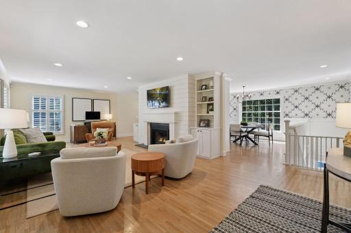 The main floor living room is the center of the home with gas fireplace flanked by built in book shelves and walls an open yet cozy feel for entertaining