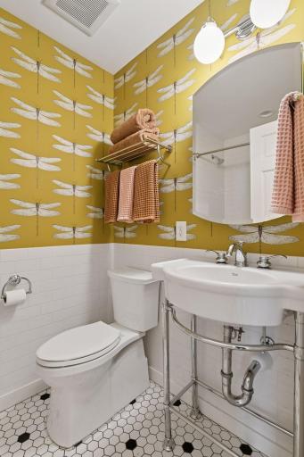 Main floor full bath with fun new wallpaper accents