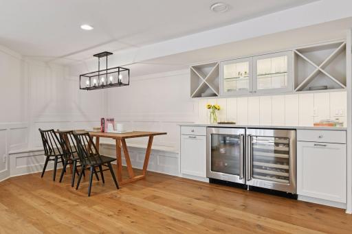 lower level entertaining is easy with dining area and wine and beverage fridges