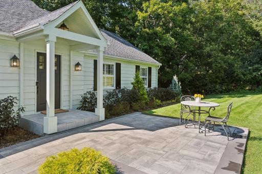 A new stone walkway and patio set the tone of Welcoming you and your guests to this charming home