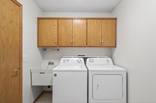 Laundry room with amble storage, utility sink, and mechanicals
