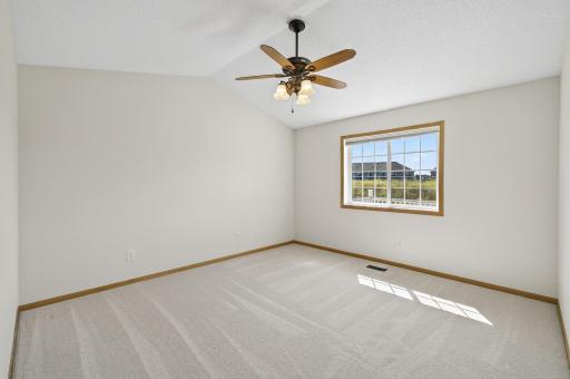 Primary bedroom with ceiling fan - new carpet and paint!