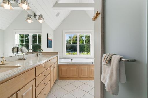 Private primary bathroom with separate tub and shower