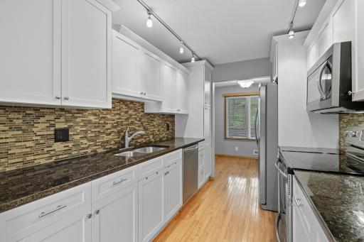 Granite counters, beautiful backsplash and newer stainless steel appliances complete the kitchen with modern updates!
