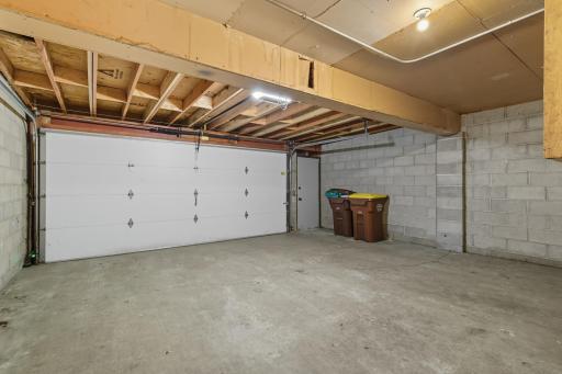 Large double garage with newer garage door opener and service door.
