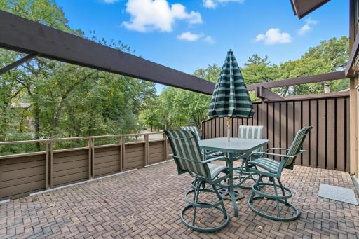Gorgeous deck space with brick-look flooring, new arbor and painted privacy wall.