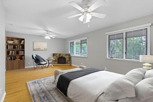 Virtually staged, The corner, electric fireplace remains with the home and makes your primary bedroom a cozy space to relax.