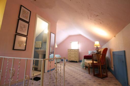 Upper-level bedroom suite with a half bath