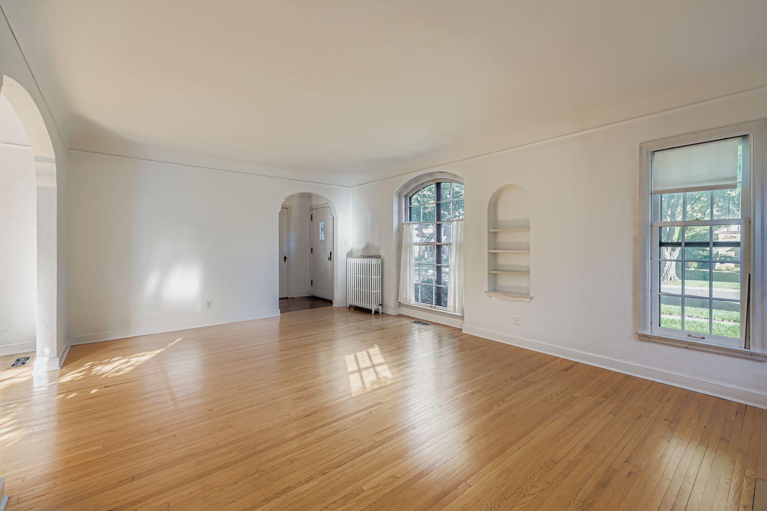 Sun filled living room with hardwood floors just waiting to be brought back to its original polished splendor. Home judiciously priced with careful consideration of work needed considered in pricing.